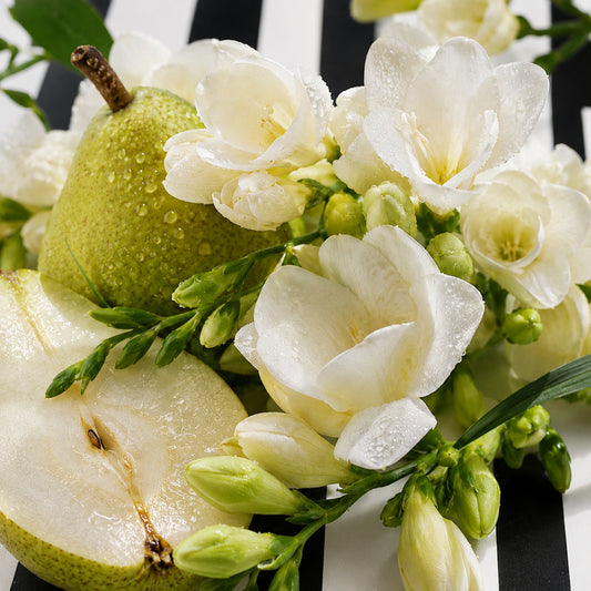 Fresh pear and white freesia flowers with water droplets